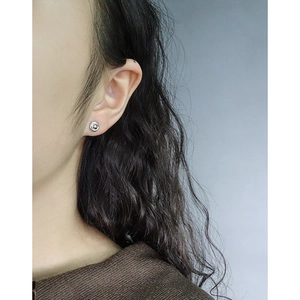 Minimalist S925 sterling silver swirl stud earring shown on ear for a delicate daily look