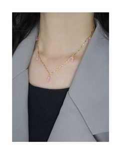 Detail of pink agate double beads pendant on a gold sterling silver clavicle necklace