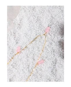 Close-up of S925 silver gold-plated necklace featuring pink agate double beads and wavy chain