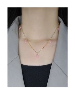 Close-up of S925 sterling silver gold necklace with pink agate double beads on model