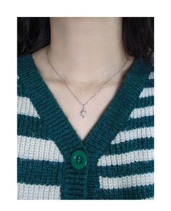 Detail of S925 silver starburst necklace with zircon stone on model neck