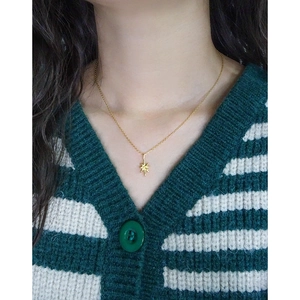 Elegant 925 sterling silver starburst pendant necklace for women on striped sweater