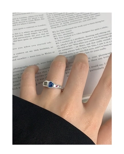 Detail of S925 silver ring featuring a blue heart gemstone and star engravings