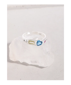 Detail of S925 silver open ring featuring a blue heart zircon and colorful gems