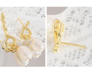 Close-up of S925 silver stamp on gold baroque pearl earrings with irregular metal design