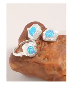 Détail d'ensemble bague et boucles d'oreilles argent avec opale bleu océan