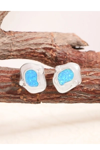 Detailed close-up of S925 silver irregular stud earrings with blue opal stones on wood