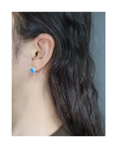 Close-up of S925 silver stud earring with blue opal in an irregular molten lava design