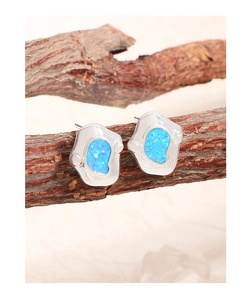 Macro view of S925 sterling silver irregular earrings with vibrant blue ocean opal stones