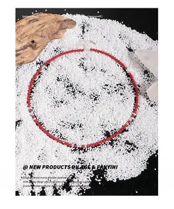 Detail of red coral bead necklace with S925 sterling silver spring clasp on white stones