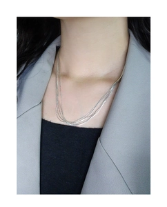 Detailed view of multilayered S925 sterling silver chain necklace on female neck