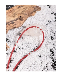 Macro detail of a red synthetic coral beaded necklace with S925 sterling silver accents
