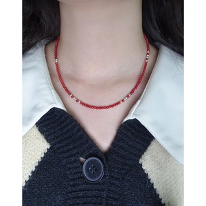 Minimalist S925 silver necklace with red synthetic coral beads on a female model