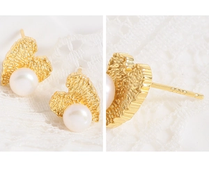 Detailed view of S925 silver needle and textured heart pearl earring with gold finish