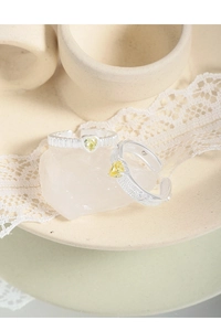Macro shot of S925 sterling silver stamp and heart-shaped yellow zircon detail