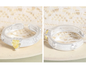 Detail of S925 sterling silver ring with heart-shaped yellow zircon and micro-pave setting