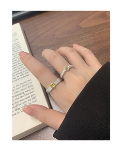 Detail of silver S925 heart-shaped green zircon rings with vintage textured bands