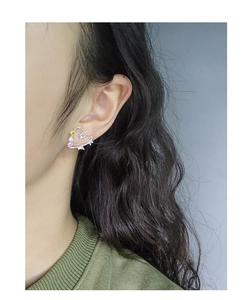 Detail of S925 silver heart earring with colorful zircon stones on model's ear