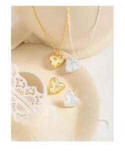 Macro shot of 925 silver heart jewelry set with micro-pave zircons on ceramic