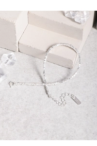 Detailed close-up of S925 sterling silver stamp on minimalist beaded bracelet link