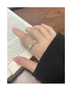 Close-up of S925 silver ring with heart-cut yellow zircon and textured braided band