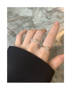 Close-up of S925 sterling silver beaded rings with natural crystal and jade stones on hand