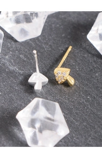 Close-up of asymmetric s925 silver mushroom stud earrings with zircon on stone