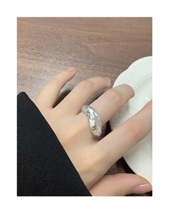 Macro detail of silver S925 ring featuring irregular lava texture and polished mirror finish
