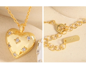 Macro detail of S925 silver heart pendant with star-set zircon and spring clasp