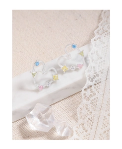 Detailed macro view of S925 silver hollow heart earrings with colorful zircon stones
