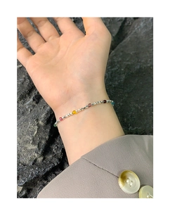 Detail of silver S925 beaded bracelet with colorful crystals on a female wrist