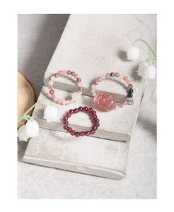 Close-up of S925 silver elastic rings with garnet beads and strawberry quartz pig charm