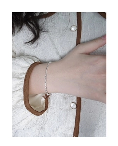 Detailed view of dainty S925 sterling silver chain with sparkling crushed silver texture