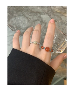 Stackable S925 silver beaded rings with natural jade and red crystal stones on model hand