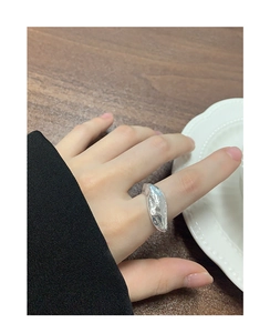 Close-up of S925 silver ring featuring irregular liquid texture on a model hand