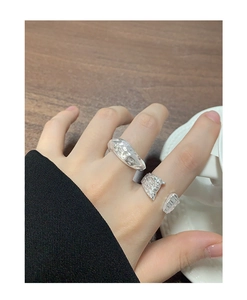Macro detail of irregular textured silver rings with organic branch-like molten design