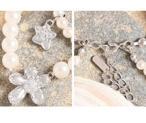 Macro shot of S925 sterling silver petal charm with pavé crystals and pearl detailing