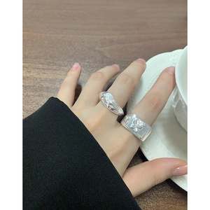 S925 silver rings set with irregular lava texture and butterfly relief on female hand