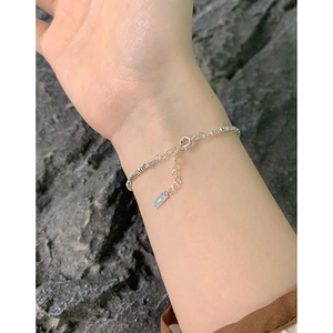 Minimalist S925 sterling silver ultra-fine chain bracelet for women on dark stone backdrop