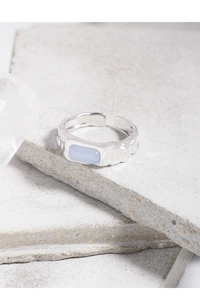 Macro shot of S925 silver ring featuring blue agate with irregular hammered texture detail