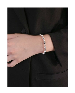 Detailed close-up of S925 sterling silver beaded bracelet on a wrist with black suit background