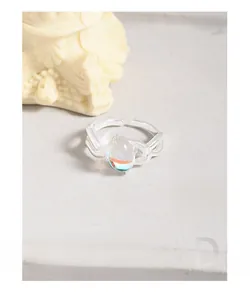 Macro detail of S925 sterling silver ring with irregular lines and moonstone inlay