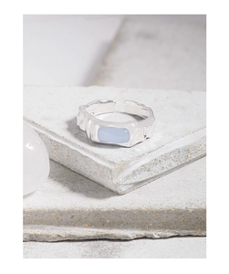 Macro shot of S925 sterling silver ring with irregular texture and blue agate stone