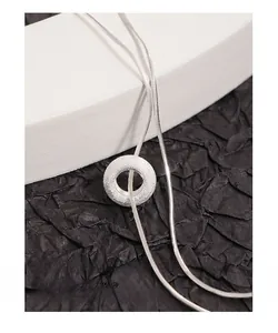 Detailed macro view of S925 silver donut pendant with frosted sand finish on snake chain