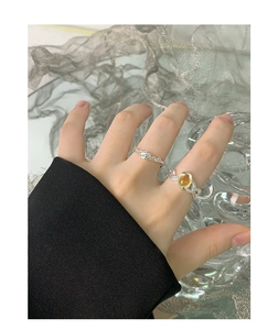 Detail of S925 sterling silver rings with irregular crossover lines and oval moonstone