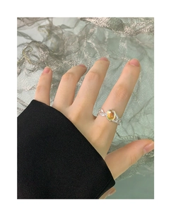 Close-up of S925 silver moonstone ring with irregular woven band on model's finger