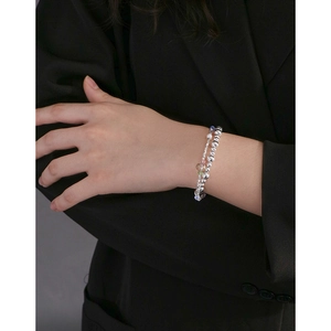 Double-layered silver beaded bracelet featuring colorful crystals worn by a model