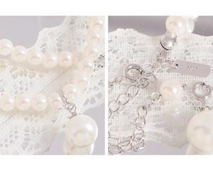 Detailed view of white pearl necklace showing S925 sterling silver clasp and hallmark