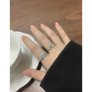 Irregular S925 silver ring with blue agate and pleated texture in elegant lifestyle setting