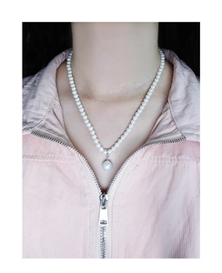 Close-up of elegant S925 silver necklace with multiple white pearls and a single pendant